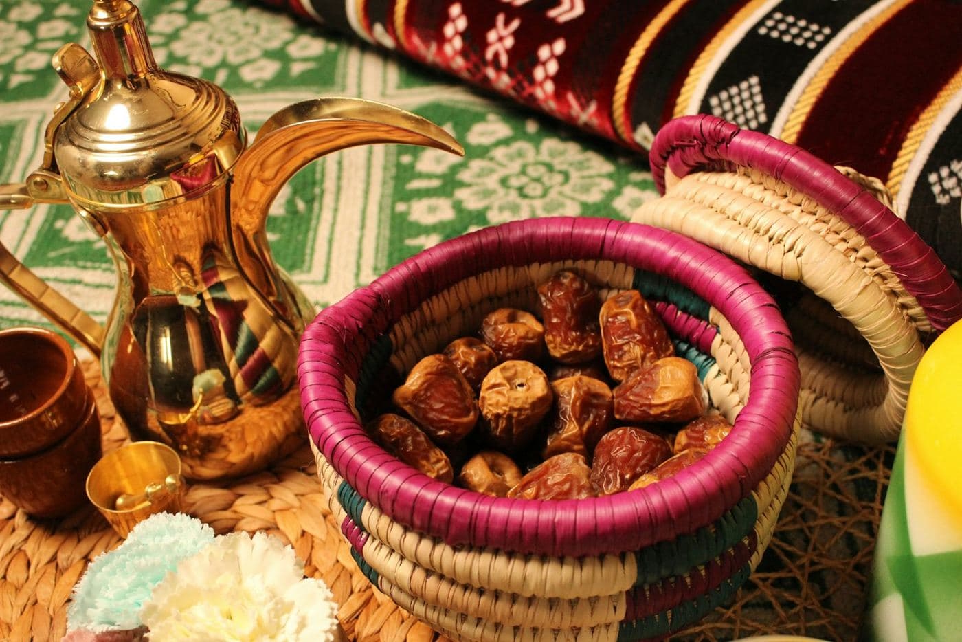 دلة قهوة عمانية وتمر في سلة سعف